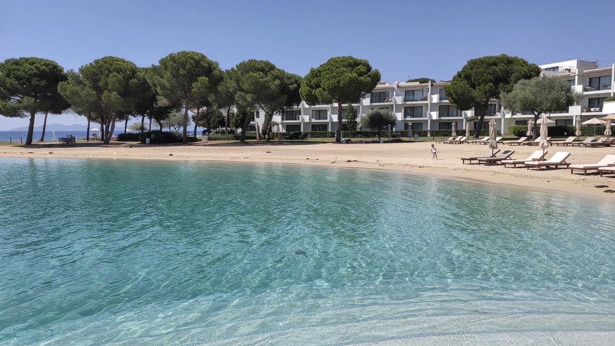 Shallow lagoon and pine-backed beach at a family resort on the Turkish Riviera